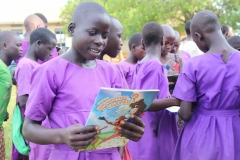 1_1.-Excited-Pupils-of-Iyolwa-Primary-School-InTororo-looking-through-the-reading-matrials-they-received